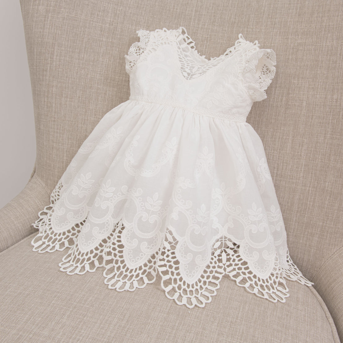 Flat lay photo of the Lily Christening Romper Dress