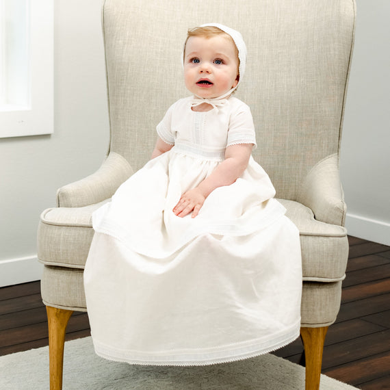 Baby boy in full-length convertible linen christening gown. 