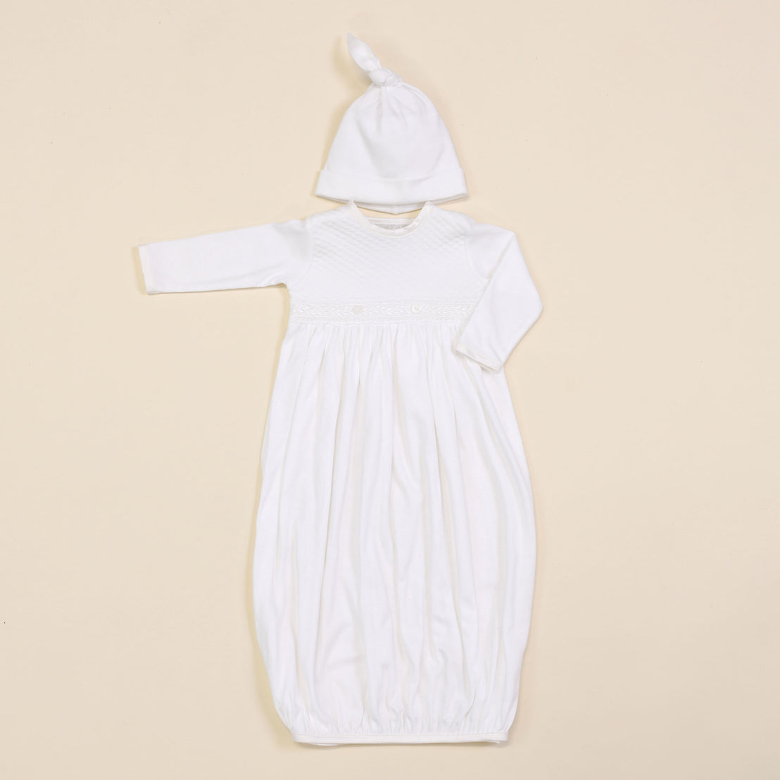 Flat lay photo of the Elijah Newborn Gown and pima Knot Hat