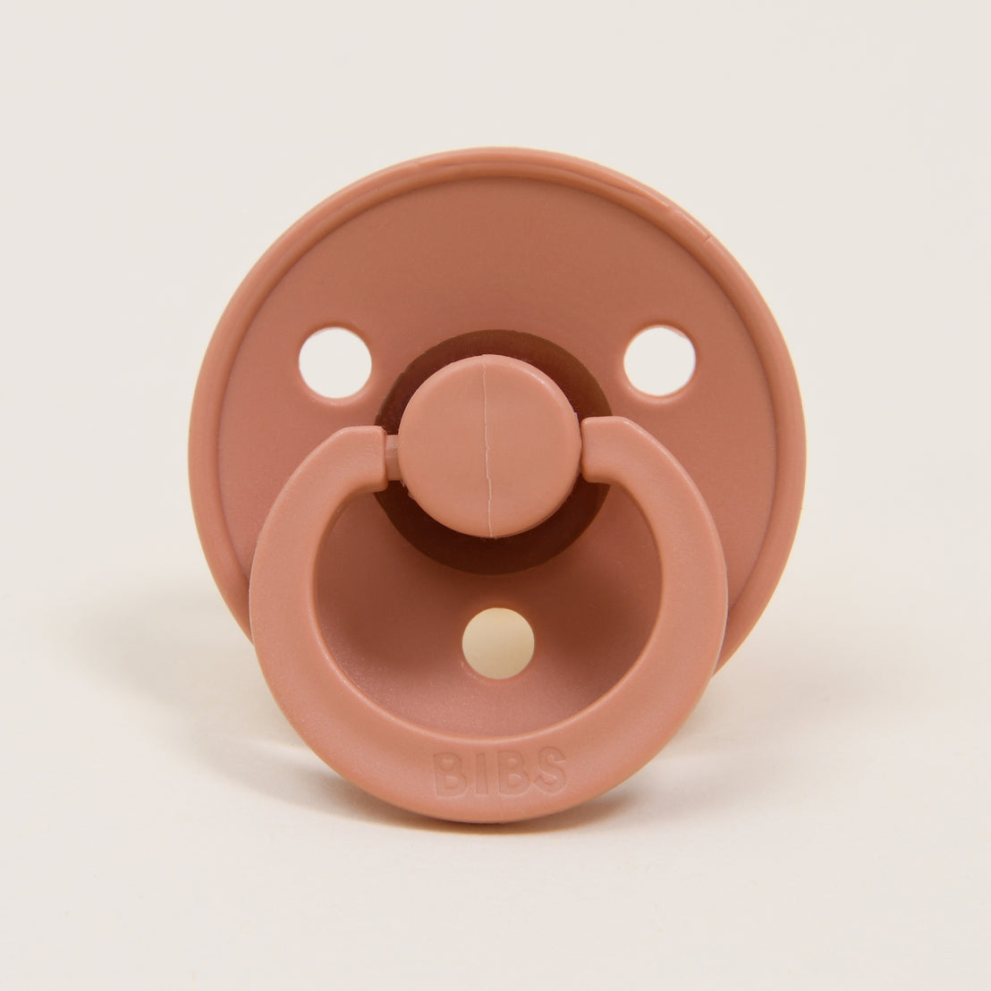 A close-up image of a Bibs pacifier set in Peach Sunsest & Woodchuck, displayed against a plain white background and ideal as an upscale baby gift.