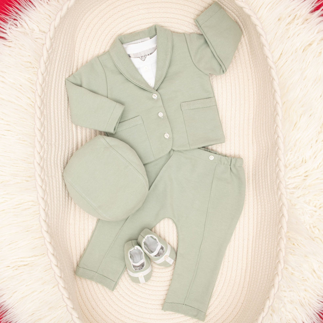Flat lay Milo sage green suit and accessories in basket
