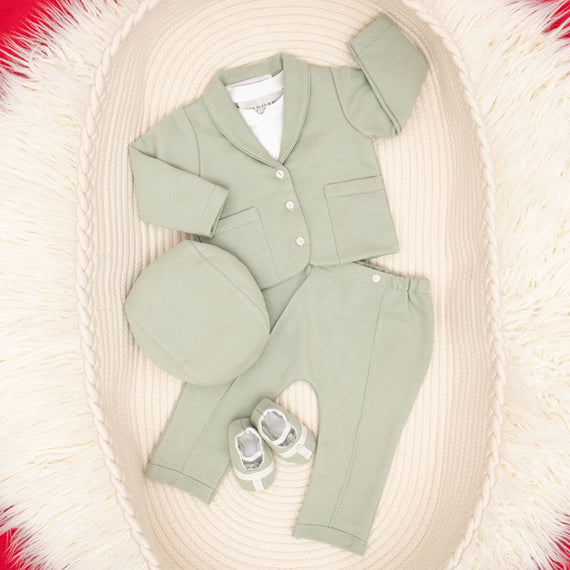 Flat lay Milo sage green suit and accessories in basket