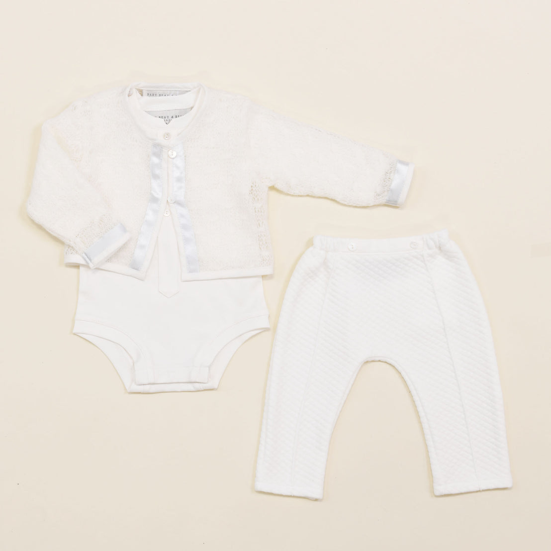 Flat lay photo of the Owen 3-Piece Suit, including the Sweater, Pants, and Onesie