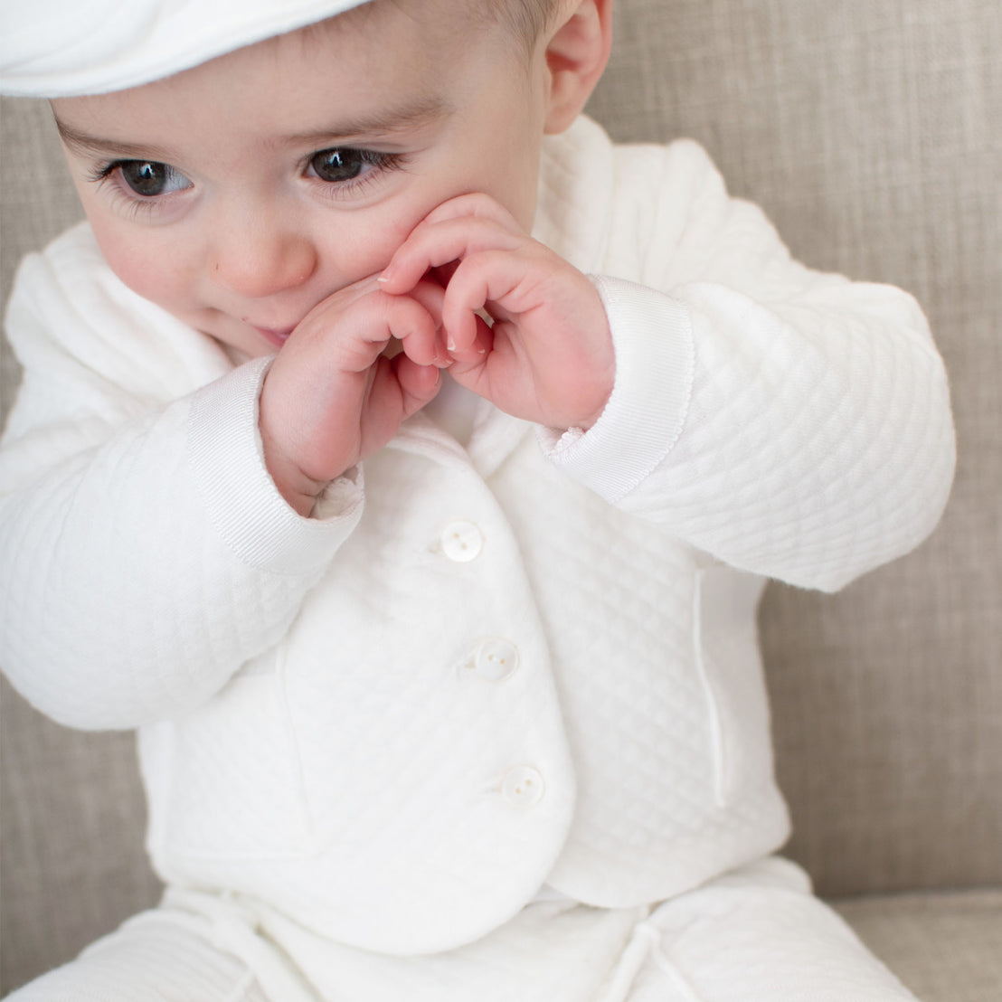 Close up detail of baby boy wearing the Elijah 3-Piece Suit. The photo shows the details of the white textured cotton