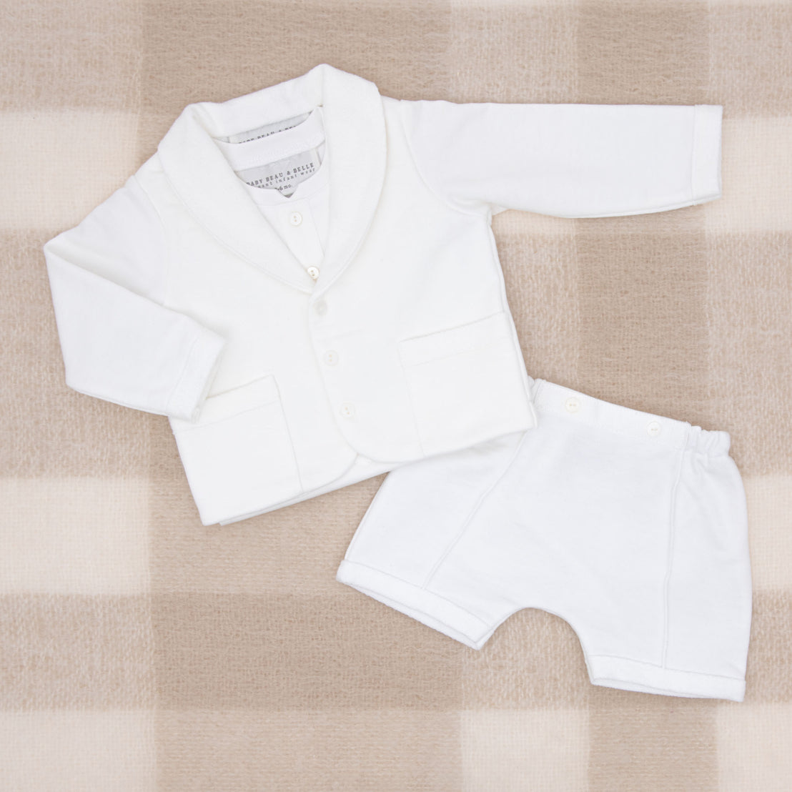 Flat lay photo of the Miles 3-Piece Suit, including the Jacket, Shorts, and Onesie