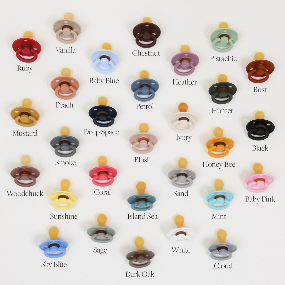 A grid of various colored Bibs Pacifiers on a light background, with each color labeled, such as ruby, vanilla, pistachio, deep space, and more.