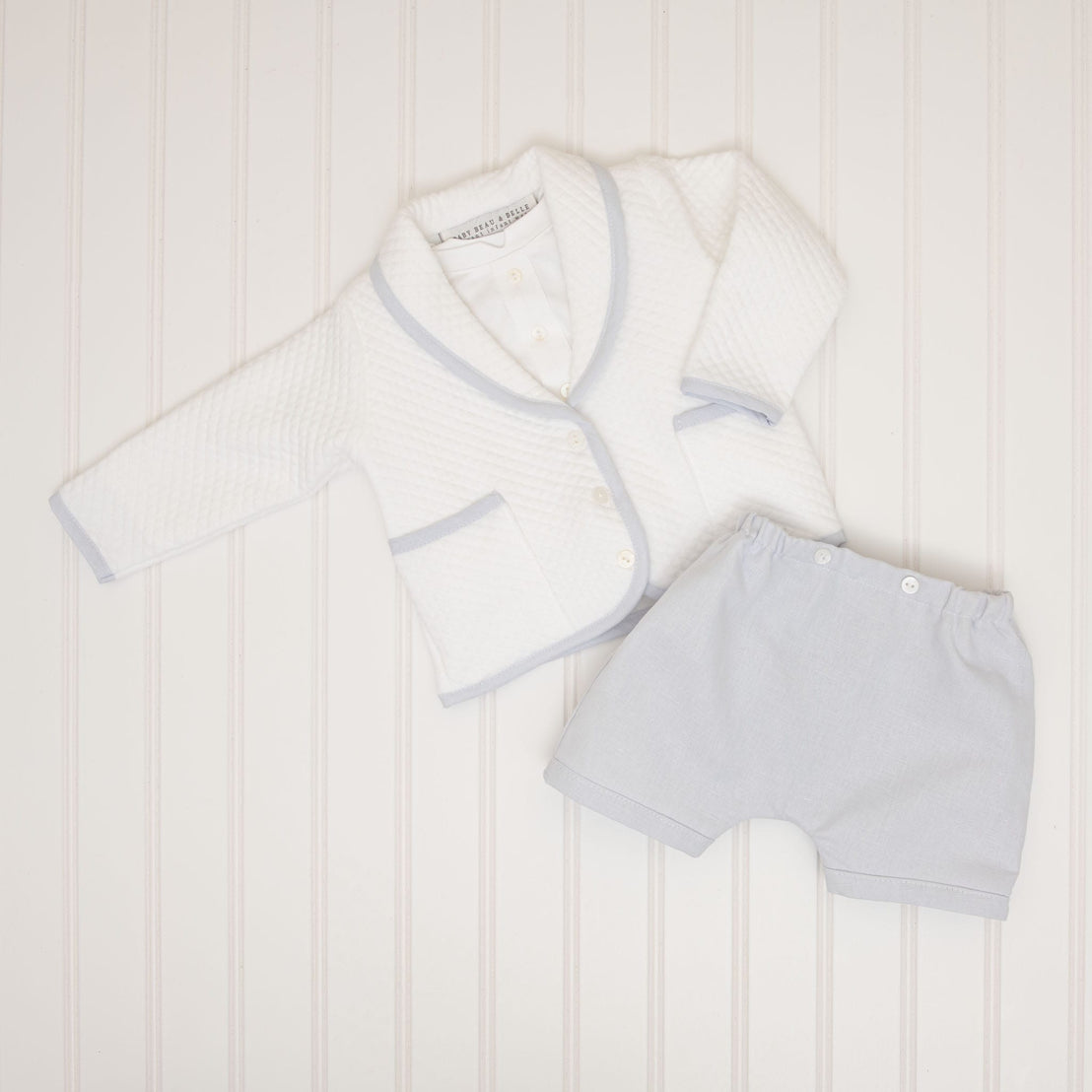The Harrison Quilted Newborn Suit paired with light blue linen shorts, showing a mix-and-match styling option.