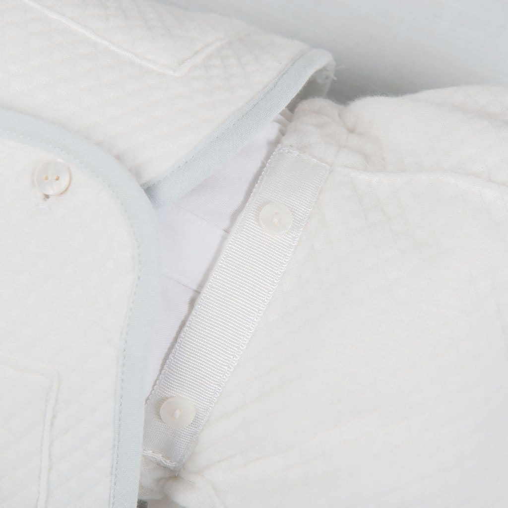 Close-up of the Harrison Quilted Newborn Suit's pants, showing button closures and soft elastic for a secure and comfortable fit.