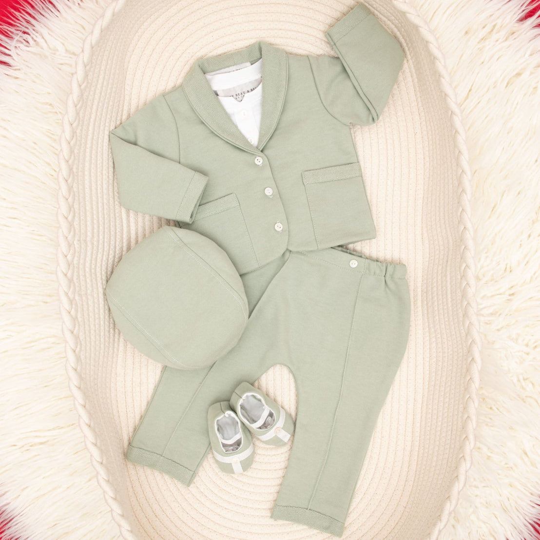 Flat lay Milo sage green suit and accessories in basket