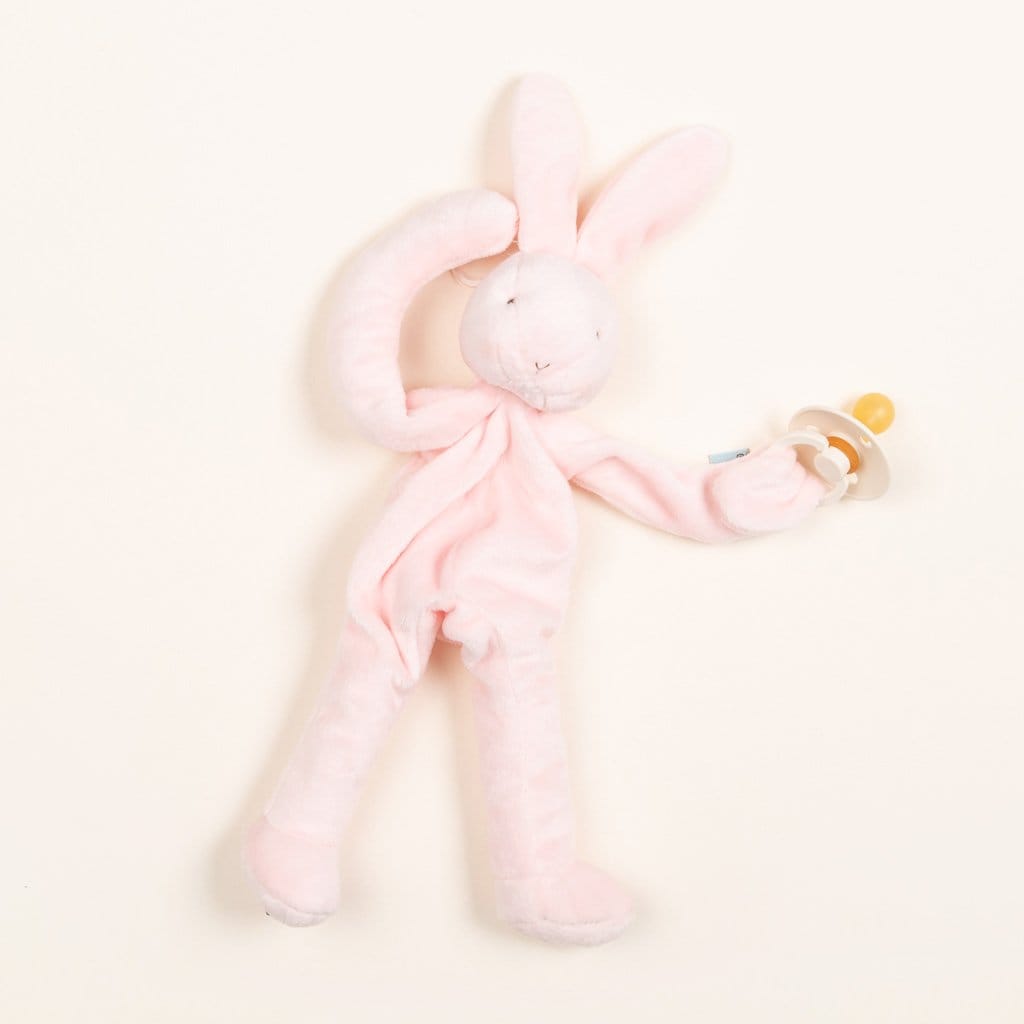 Ideal as a baby gift, the Pink Silly Bunny Buddy serves as a soft stuffed toy holding a pacifier in its right paw. With elongated ears and an understated embroidered face, this charming piece complements any nursery setting beautifully.