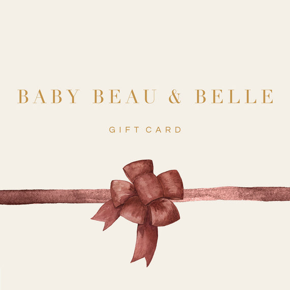 The Gift Card features elegant gold text displaying "BABY BEAU & BELLE" above the words "GIFT CARD" on its cream-colored surface. A textured brown ribbon, tied in a bow, adorns the lower part of the card, making it ideal for those ready to redeem at checkout.