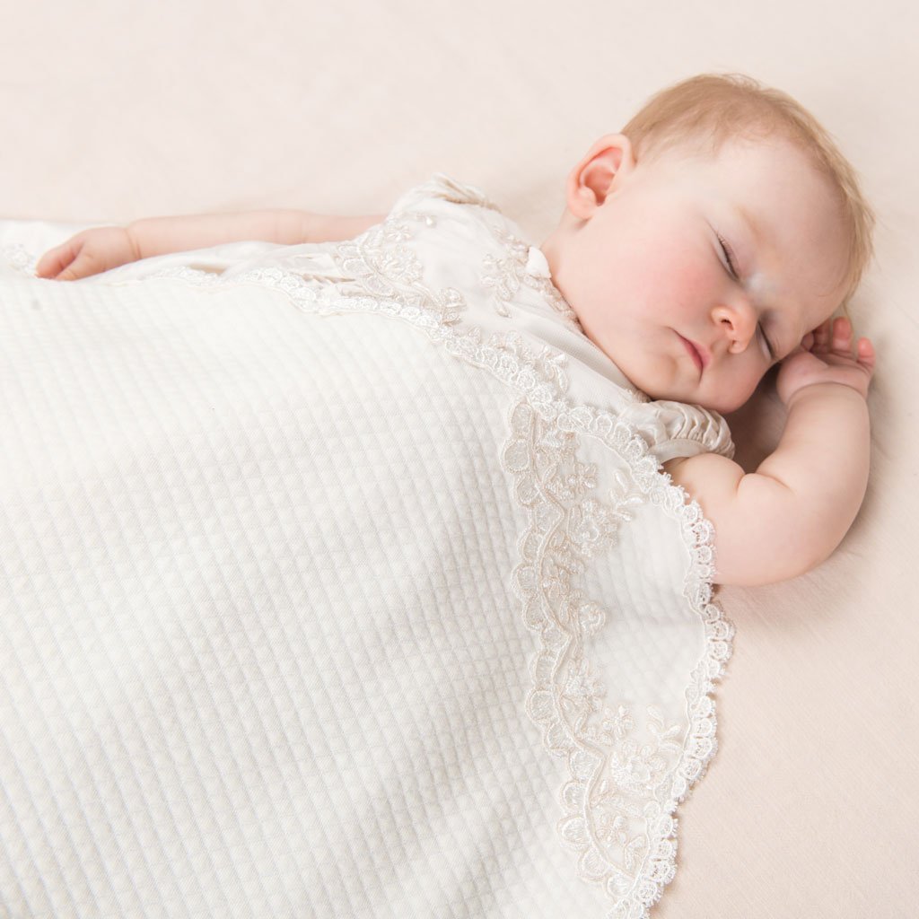 Baby girl sleeping in the Penelope Receiving Blanket.